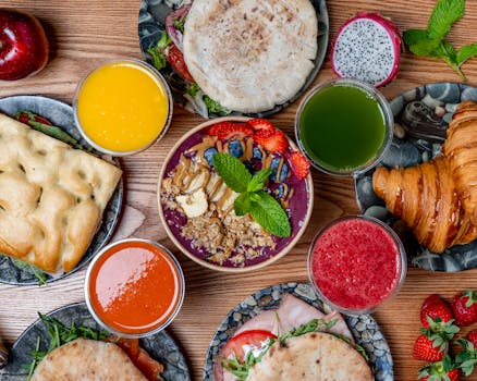 Vibrant breakfast spread featuring smoothies, pastries, and fresh fruits. Perfect for a healthy start.